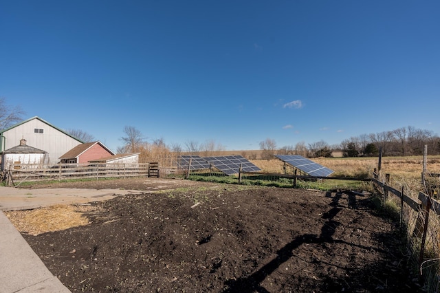 view of yard with fence and a rural view