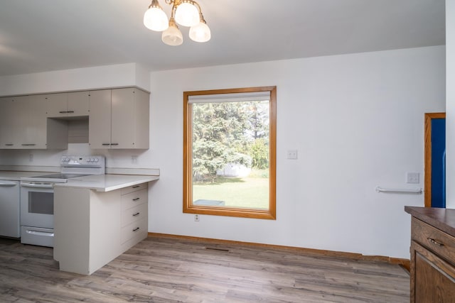 kitchen featuring a notable chandelier, white appliances, baseboards, light countertops, and light wood-type flooring