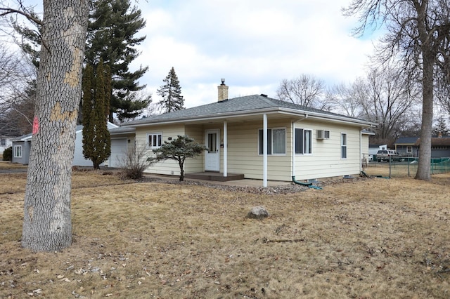 ranch-style house with a garage, fence, and a chimney