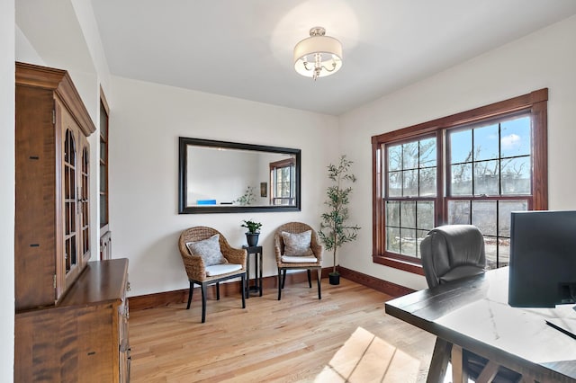 home office featuring light wood finished floors and baseboards