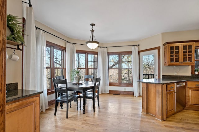 dining space with light wood-style floors and baseboards