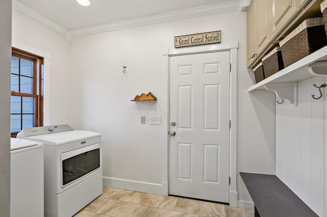 clothes washing area featuring ornamental molding, washing machine and dryer, cabinet space, light tile patterned floors, and baseboards