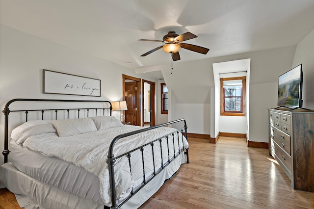 bedroom with ceiling fan, baseboards, and wood finished floors