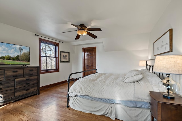 bedroom with ceiling fan, baseboards, and wood finished floors