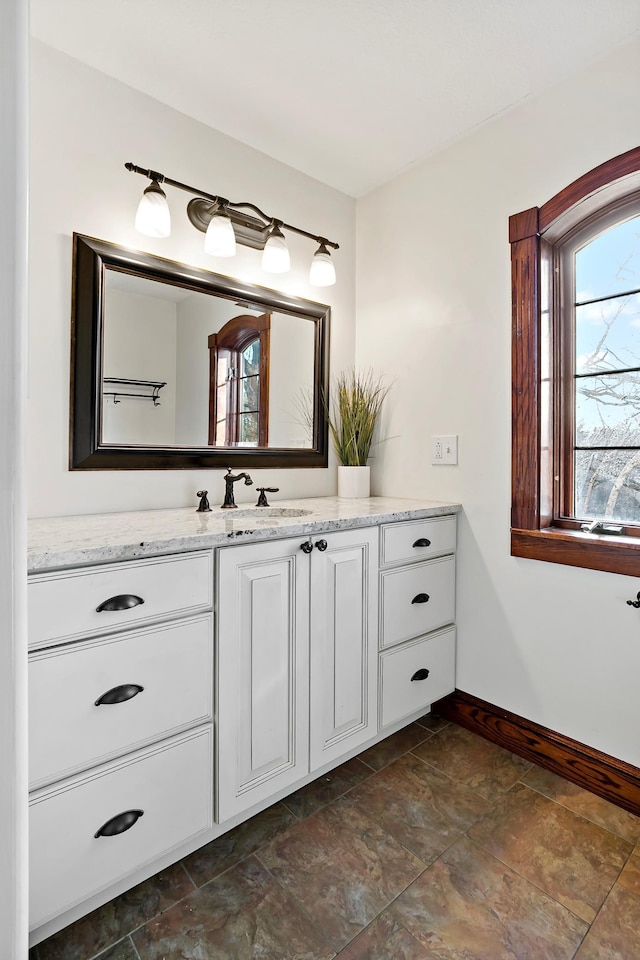 bathroom featuring vanity and baseboards