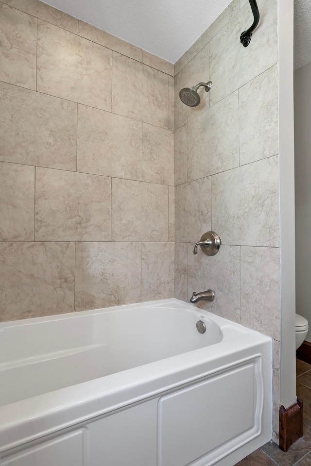 bathroom featuring toilet and shower / bathtub combination