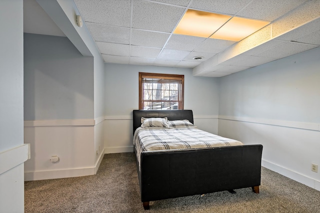 carpeted bedroom with a drop ceiling, visible vents, and baseboards