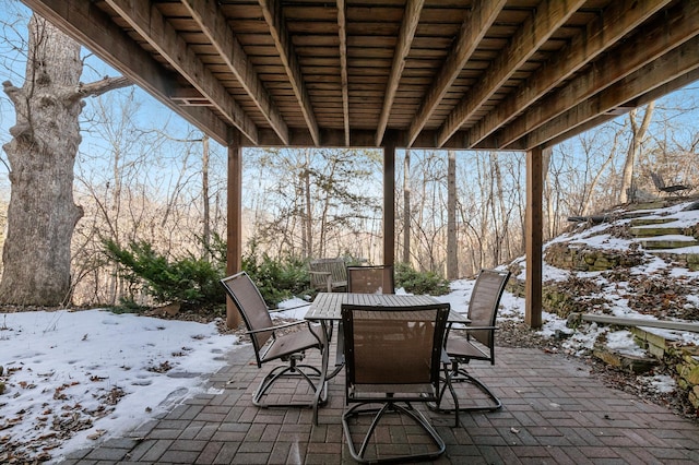 snow covered patio with outdoor dining area