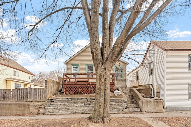 back of property featuring stairway, fence, and a wooden deck