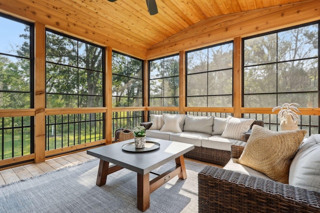 sunroom with lofted ceiling, ceiling fan, and wood ceiling