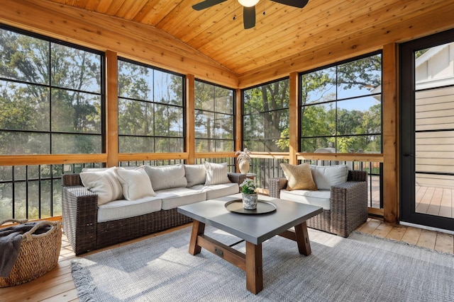 sunroom / solarium with lofted ceiling, wood ceiling, and a ceiling fan