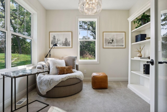 sitting room featuring carpet, visible vents, a notable chandelier, and baseboards