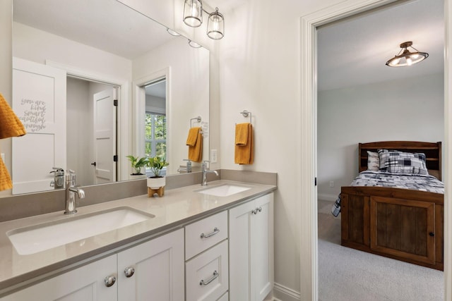 bathroom featuring double vanity, baseboards, and a sink