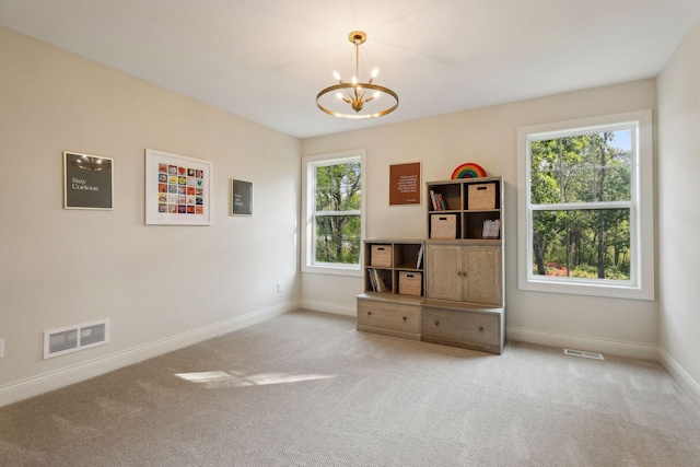 interior space with an inviting chandelier, baseboards, visible vents, and carpet flooring