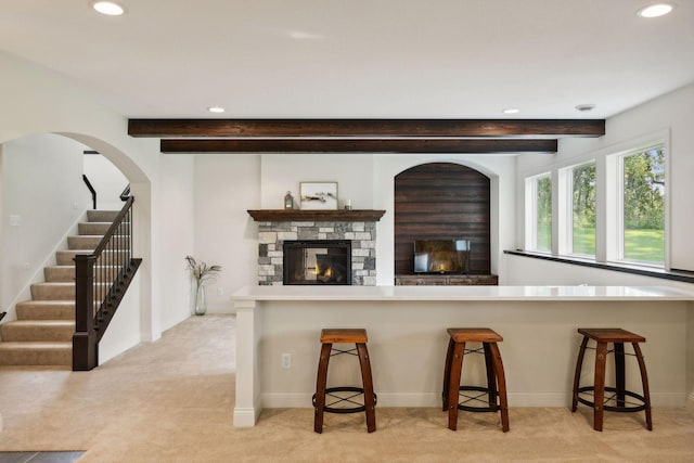 kitchen featuring recessed lighting, beam ceiling, and light colored carpet