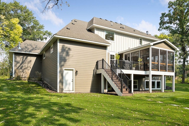 rear view of property with a sunroom, stairway, and a lawn