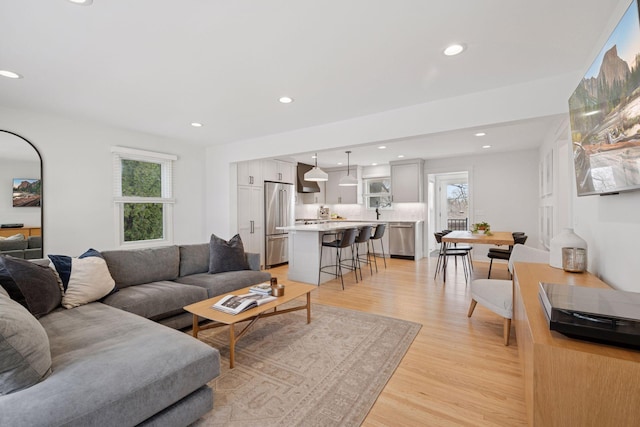 living room with recessed lighting and light wood finished floors