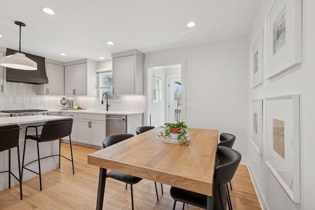 dining space with recessed lighting, baseboards, and light wood-style flooring