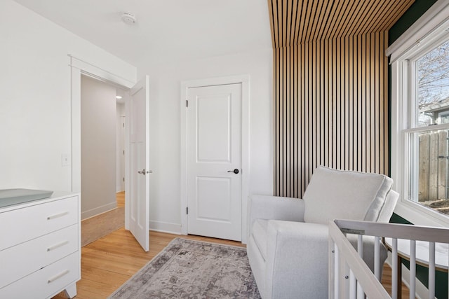 bedroom featuring light wood-type flooring and baseboards