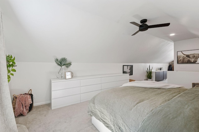 carpeted bedroom featuring ceiling fan, baseboards, and lofted ceiling