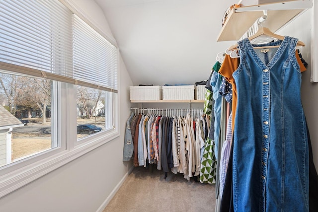 walk in closet featuring carpet floors and lofted ceiling