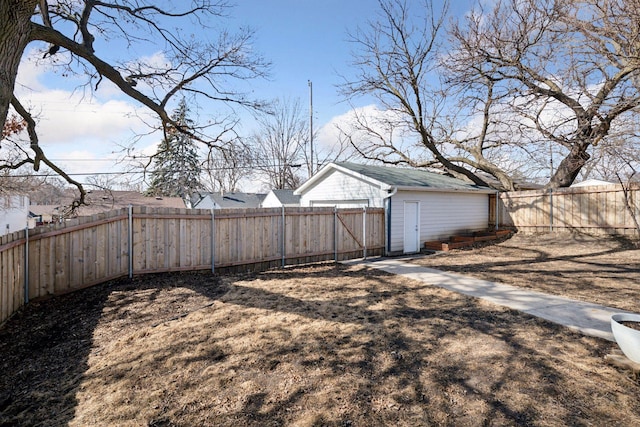 view of yard featuring an outdoor structure and a fenced backyard