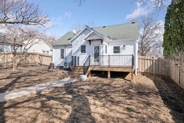 back of house featuring a wooden deck, a fenced backyard, and a shingled roof