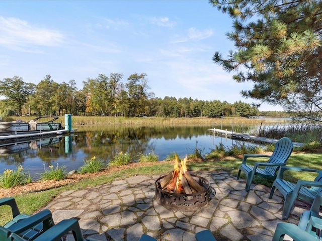 view of patio with a water view and an outdoor fire pit