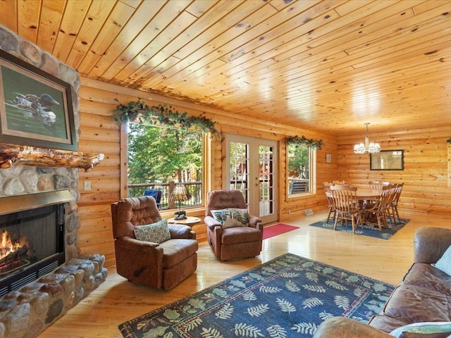 living room with a stone fireplace, wooden ceiling, an inviting chandelier, rustic walls, and wood-type flooring