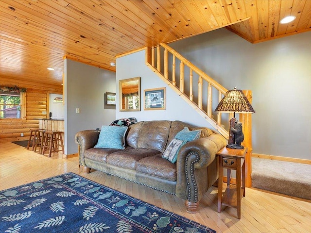 living area featuring hardwood / wood-style flooring, recessed lighting, wooden ceiling, log walls, and baseboards