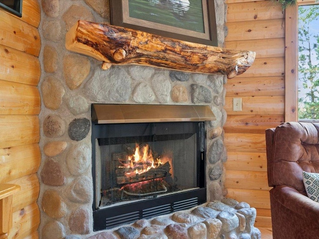 room details with rustic walls and a stone fireplace