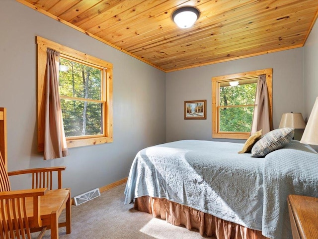 carpeted bedroom featuring multiple windows, wood ceiling, visible vents, and baseboards