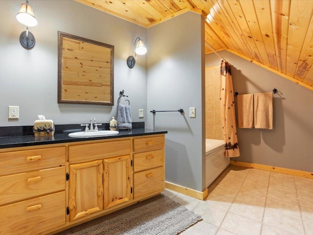 bathroom featuring baseboards, wood ceiling, and vanity