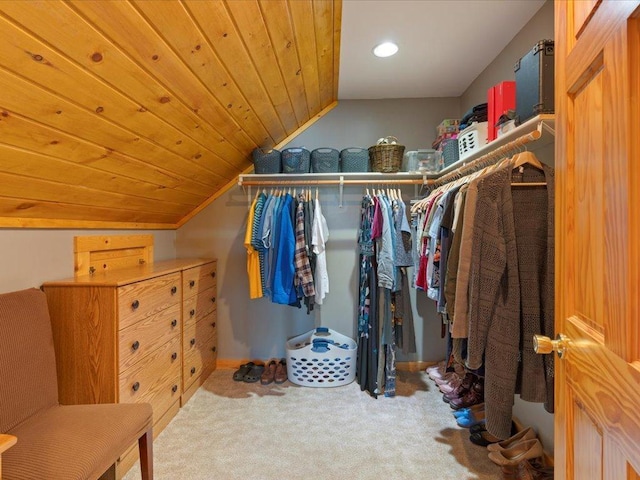 walk in closet with carpet and vaulted ceiling