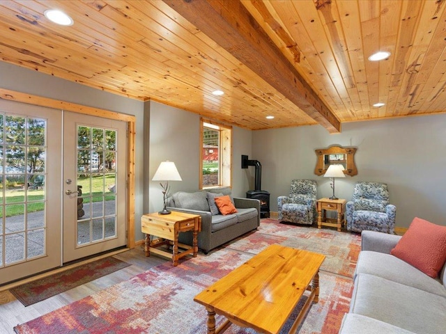 living area featuring beamed ceiling, recessed lighting, wooden ceiling, french doors, and a wood stove