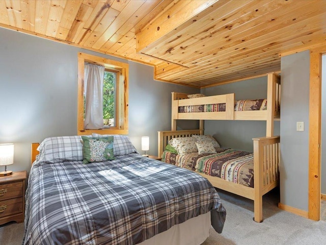 bedroom featuring carpet flooring, wood ceiling, and baseboards