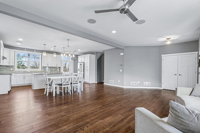 living area featuring visible vents, baseboards, ceiling fan, dark wood finished floors, and recessed lighting