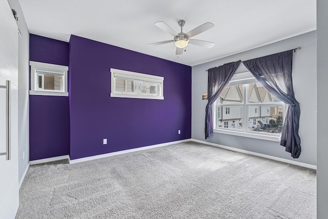 spare room with baseboards, carpet floors, and ceiling fan