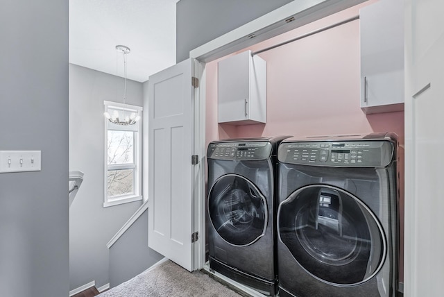 laundry room with a notable chandelier, washer and dryer, cabinet space, carpet, and baseboards