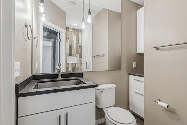 bathroom with toilet and vanity