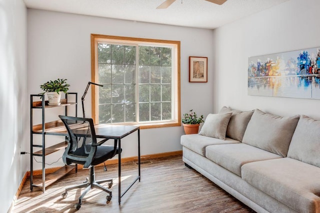 office area with ceiling fan, baseboards, and wood finished floors