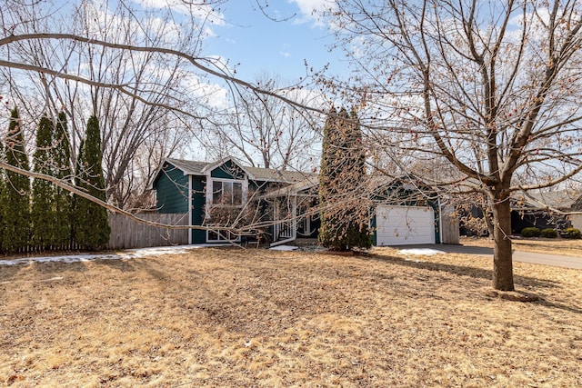 view of front of property featuring a garage, driveway, and roof with shingles