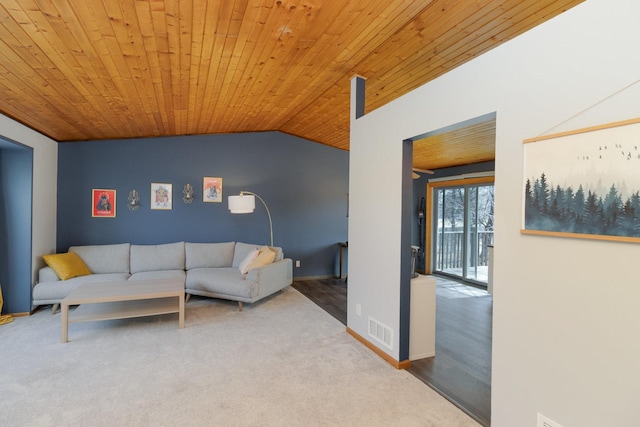 living area featuring lofted ceiling, baseboards, visible vents, and wooden ceiling