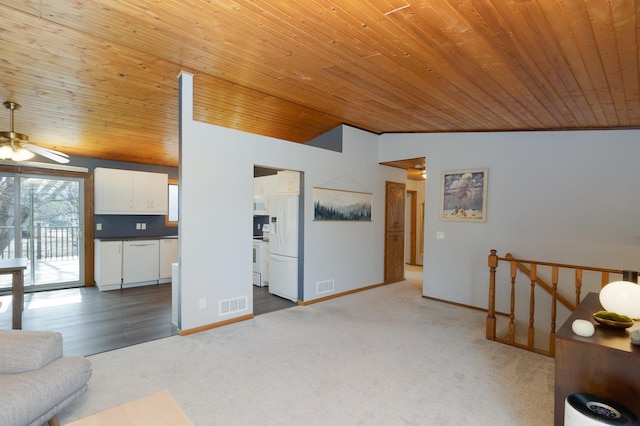 unfurnished living room featuring visible vents, a ceiling fan, carpet, and vaulted ceiling