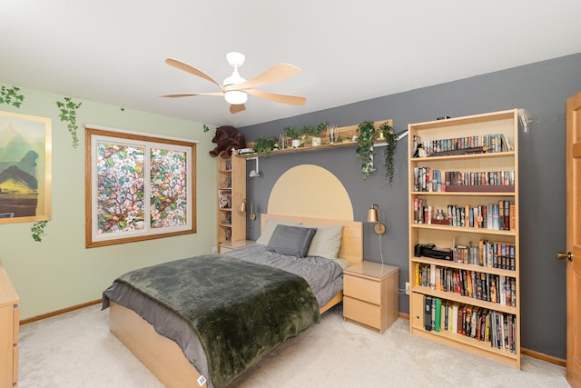 bedroom featuring baseboards, ceiling fan, and carpet flooring