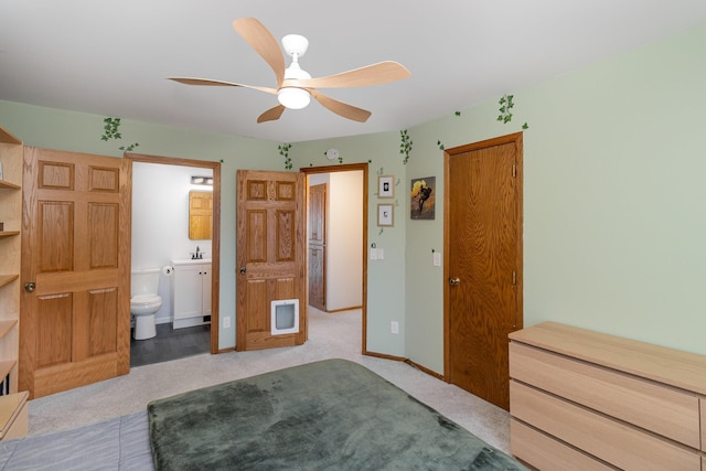 bedroom with a sink, baseboards, carpet, and ensuite bathroom