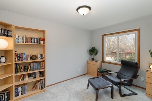 sitting room with baseboards and carpet floors