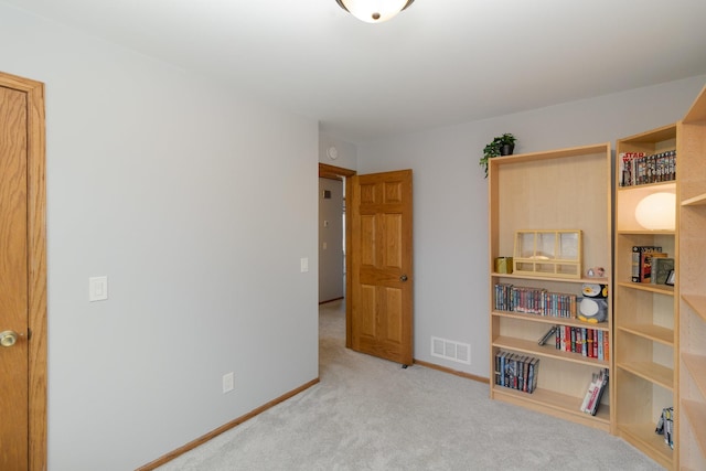 interior space with carpet flooring, baseboards, and visible vents