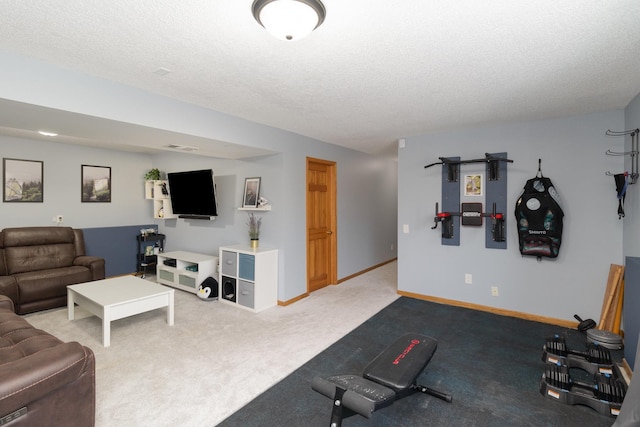 workout room with carpet flooring, baseboards, and a textured ceiling