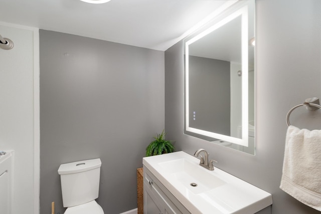 half bathroom with toilet and vanity